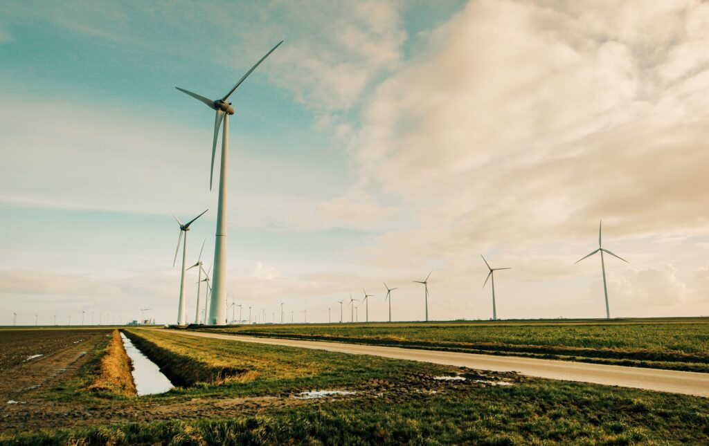 windmill energy on green grass field